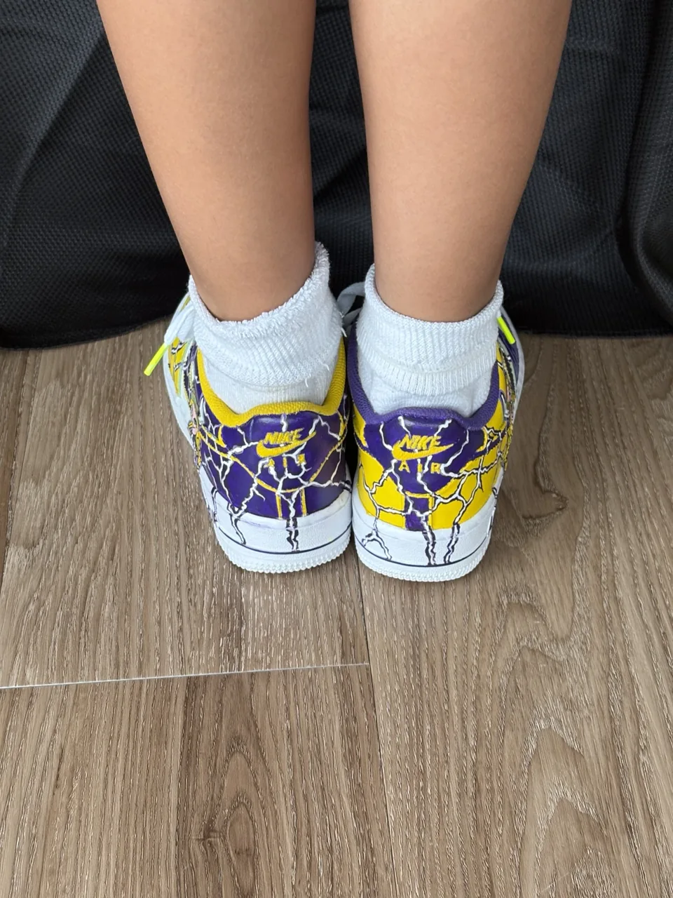 Rear view showing the hand-painted heels of both shoes